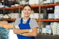 Young woman in uniform posing in warehouse Royalty Free Stock Photo