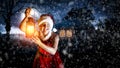 Young woman in a uniform of Santa Claus with a lit lantern on a winter Christmas night background. Royalty Free Stock Photo