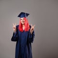 Young woman is a university graduate. Happy graduate master in a robe and cap.