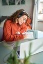 Young woman university student wearing headphones using laptop elearning. Royalty Free Stock Photo