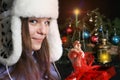 Young Woman Unwrapping Christmas Gift