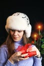 Young Woman Unwrapping Christmas Gift