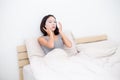 Young woman use of the paper mask on face and relax on bed