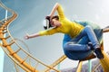 Young woman used Virtual reality helmet VR. She see Roller coaster park Royalty Free Stock Photo