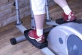 Young woman uses an elliptical cross trainer in the gym Royalty Free Stock Photo