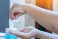 Young woman uses her hand to press hand sanitizer bottle to clean her hand. Hand sanitizer alcohol gel rub clean hands hygiene Royalty Free Stock Photo