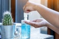 Young woman uses her hand to press hand sanitizer bottle to clean her hand. Hand sanitizer alcohol gel rub clean hands hygiene Royalty Free Stock Photo