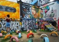 A young woman uses a mobile phone at Graffiti Park