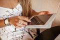 Young woman uses tablet in cafe