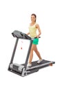 Young woman uses treadmill.