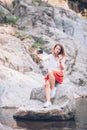 Young woman usin smartphone on the lake