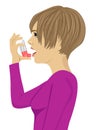 Young woman using an asthma inhaler