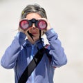 Young woman using binoculars outdoor Royalty Free Stock Photo