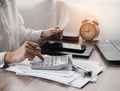 Young woman using calculator calculating monthly home expenses, taxes, bank account balance and credit card bills payment Royalty Free Stock Photo