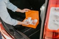 Young woman using car first aid kit box with kind of a medical aids, transport concept