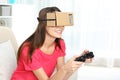 Young woman using cardboard virtual reality headset Royalty Free Stock Photo