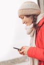 Young woman using cell phone texting, typing and smiling Royalty Free Stock Photo