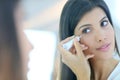 Young woman using concealer Royalty Free Stock Photo