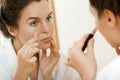 Woman using concealer for under eye circles Royalty Free Stock Photo