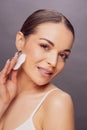 Young woman using a cotton pad to remove her make-up. Beauty ski Royalty Free Stock Photo