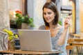 Young woman using credit bank card laptop computer while transferring money order food in cafeteria Royalty Free Stock Photo