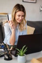 A young woman using a credit card at home to make a purchase or payment over the internet Royalty Free Stock Photo