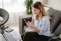 A young woman using a credit card at home to make a purchase or payment over the internet Royalty Free Stock Photo