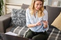 A young woman using a credit card at home to make a purchase or payment over the internet Royalty Free Stock Photo