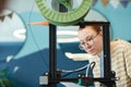 Young Woman using 3D Printer