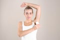 Young woman using deodorant Royalty Free Stock Photo