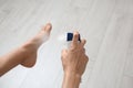 Young woman using deodorant for feet at home Royalty Free Stock Photo