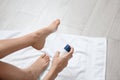 Young woman using deodorant for feet at home Royalty Free Stock Photo