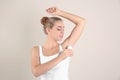 Young woman using deodorant Royalty Free Stock Photo