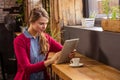 Young woman using digital tablet in cafeteria Royalty Free Stock Photo