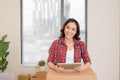 Young woman using digital tablet during moving in new apartment Royalty Free Stock Photo