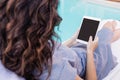 Young woman using digital tablet near poolside Royalty Free Stock Photo