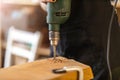 Young woman using electric drill