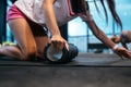 Young woman using a foam roller while doing stretching exercises Royalty Free Stock Photo