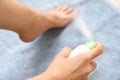 Young woman using foot deodorant at home Royalty Free Stock Photo