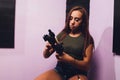 Young woman using a gimbal camera stabilizer to take footage inside a house. Filming different antiques using a