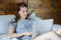 Young woman using her laptop on bed Royalty Free Stock Photo