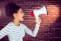 Young woman using her megaphone in the light Royalty Free Stock Photo