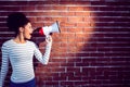 Young woman using her megaphone in the light Royalty Free Stock Photo