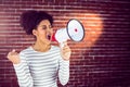 Young woman using her megaphone in the light Royalty Free Stock Photo