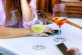 Young woman using her mobile having a drink in a bar outdoors, Italy Royalty Free Stock Photo