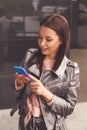 Young woman using her phone at the office building