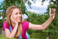 Young woman using her smart phone at the park Royalty Free Stock Photo