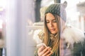 Young woman using her smart phone while sitting in a bus - Pretty girl connecting on her social network with her mobile phone Royalty Free Stock Photo