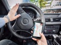 Young woman using her smartphone as GPS.