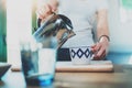 Young woman using kettle for make tea or black coffee on kitchen at room interior background.Women`s hands pour water Royalty Free Stock Photo